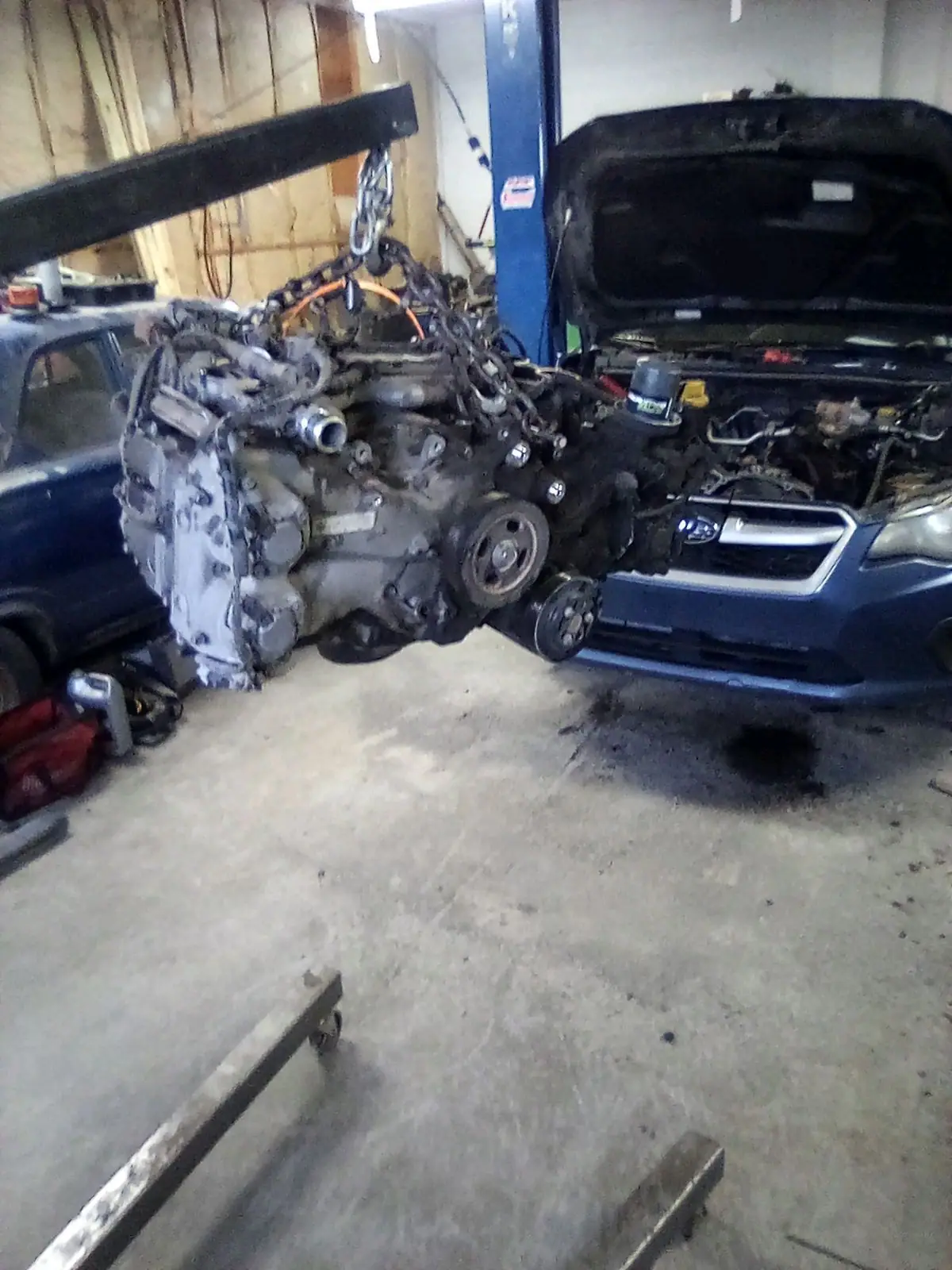 Engine lifted out of a Subaru on an engine hoist