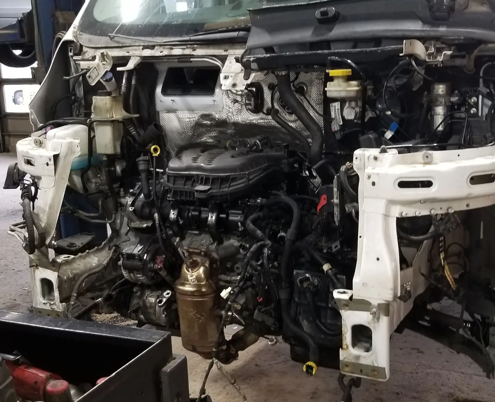 Van with the front end stripped down for engine work