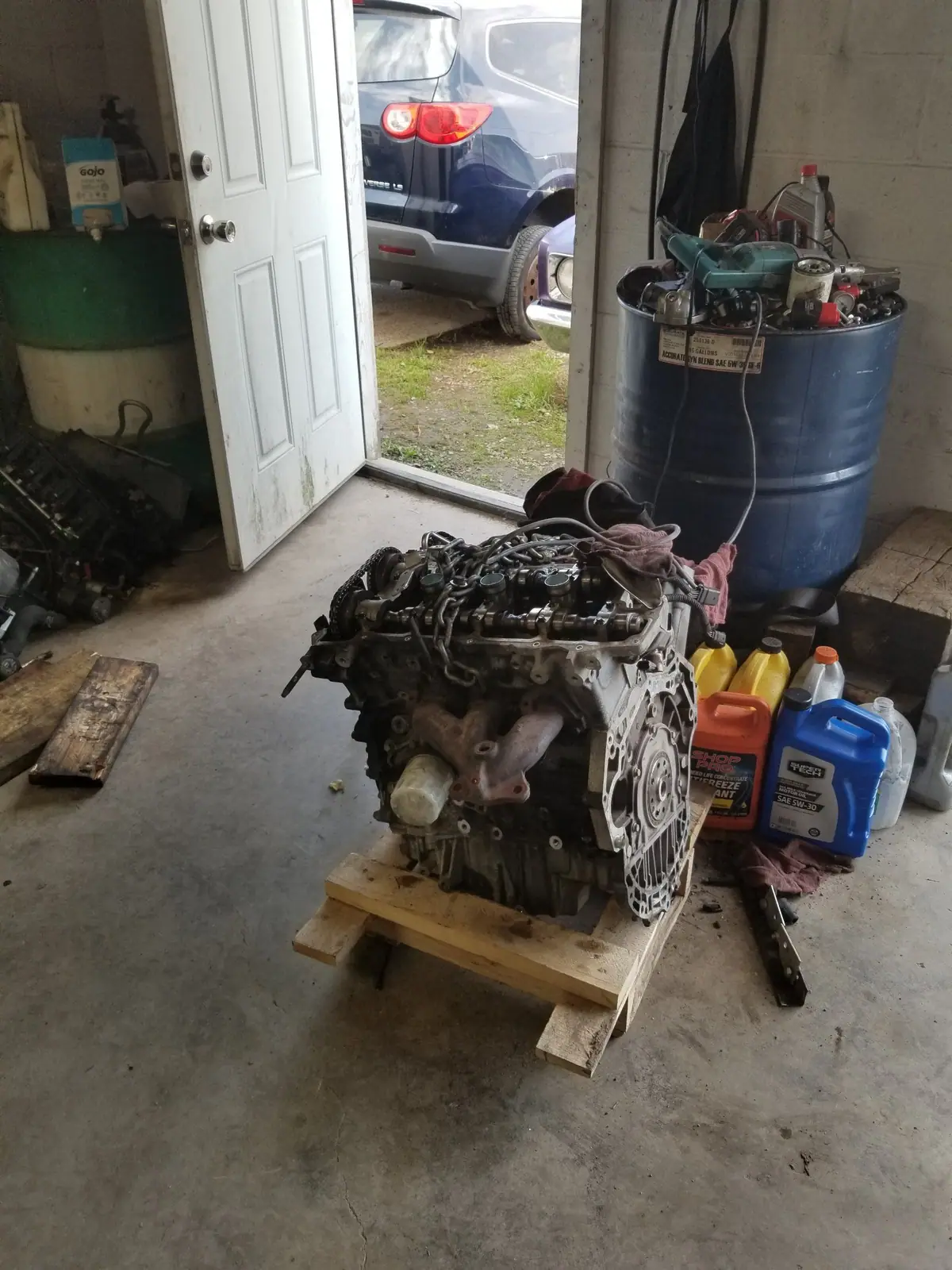 Replacement engine on a pallet in the shop doorway