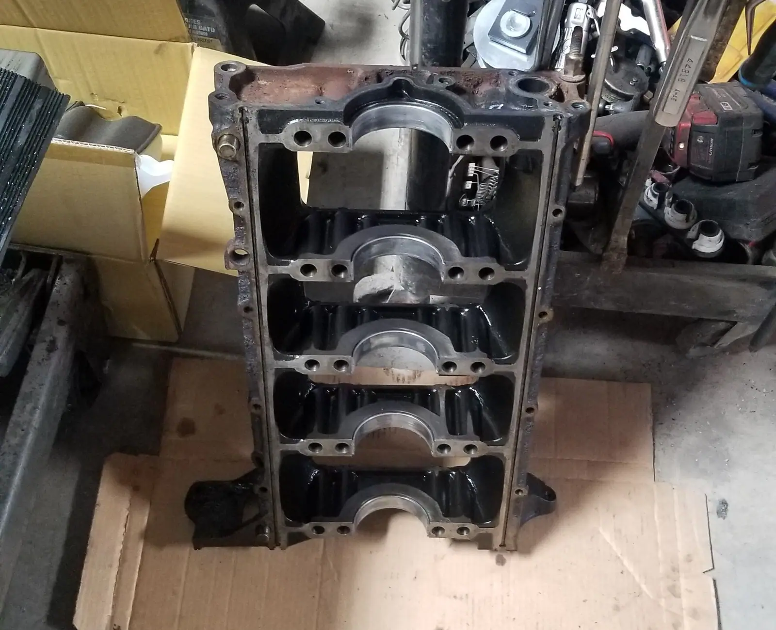 Engine block upside down on the bench showing the main bearing caps