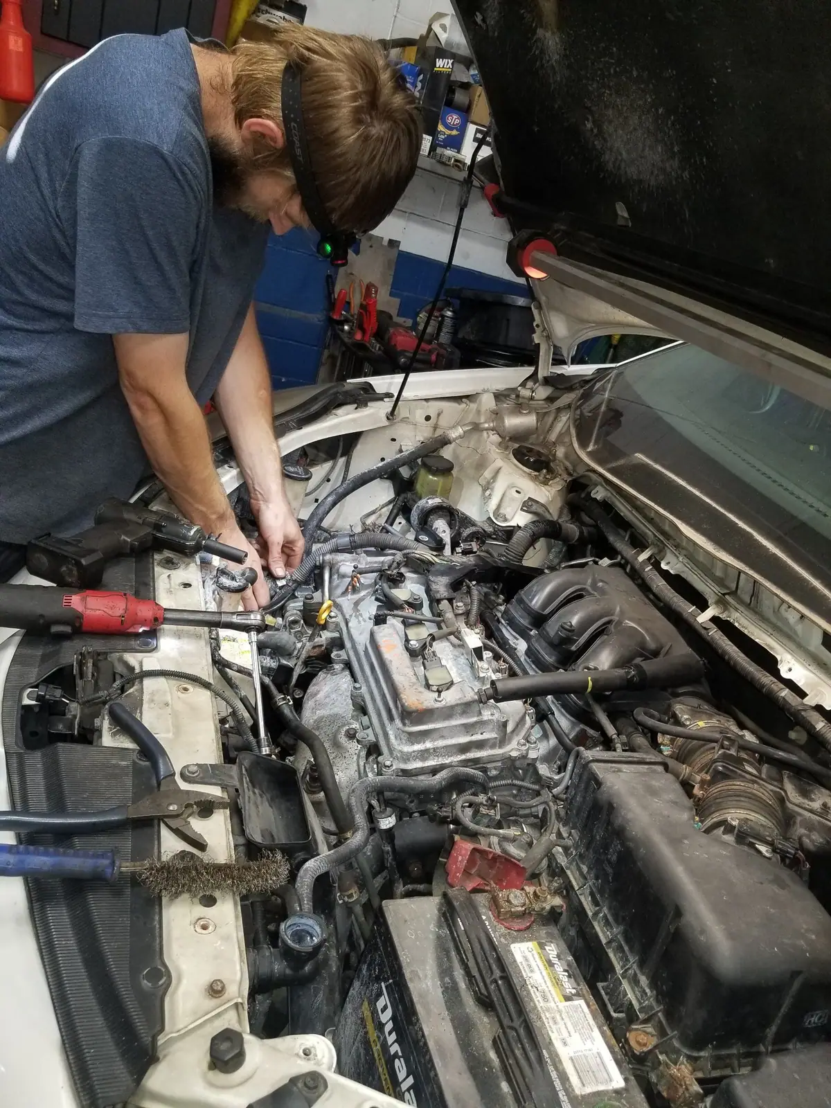J&W mechanic working in an engine bay