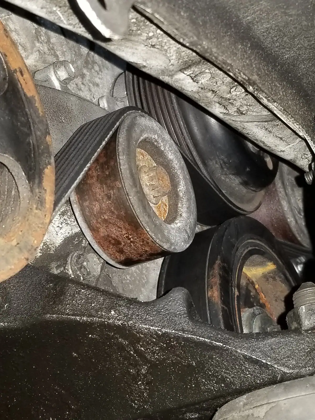 Serpentine belt tensioner and idler pulleys up close