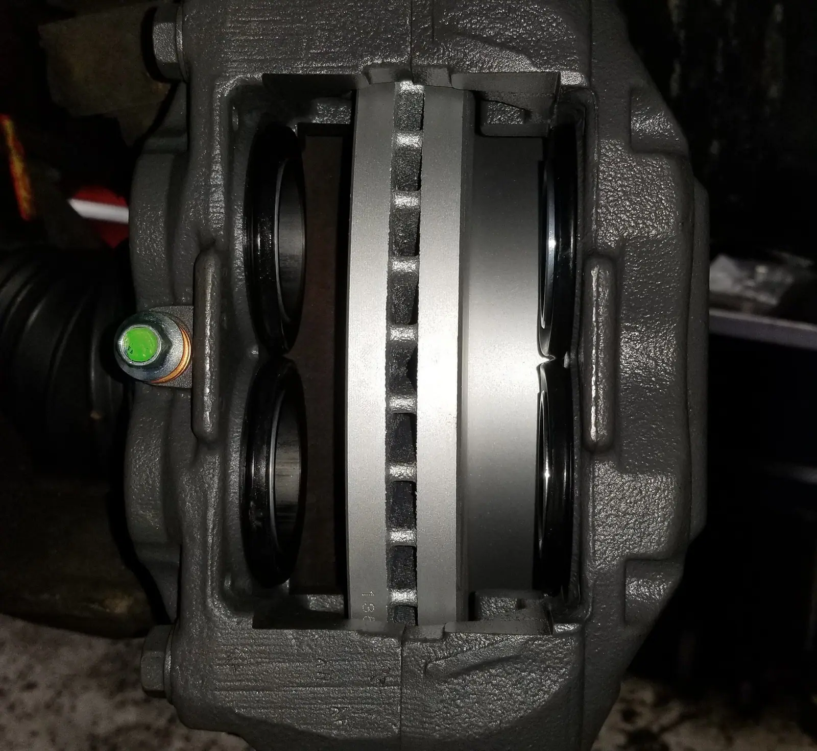New brake caliper and rotor installed on a front hub
