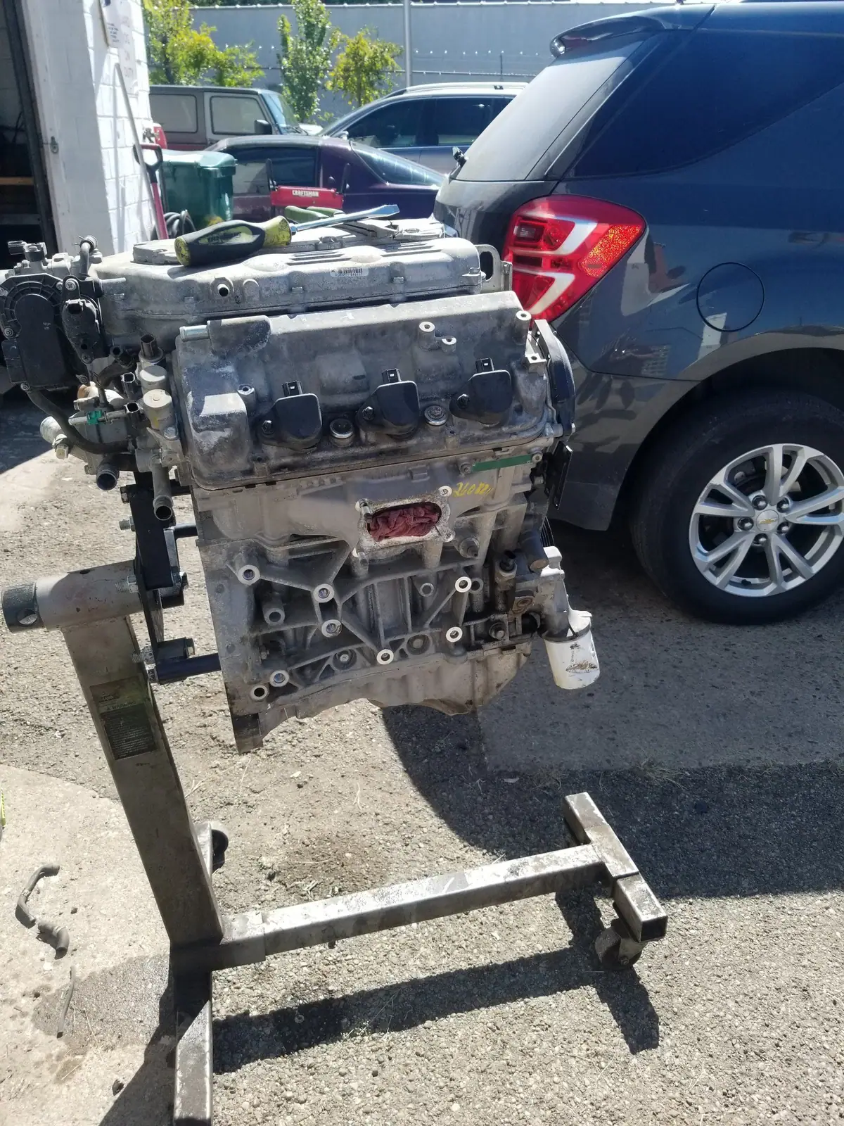 V6 on an engine stand outside the shop